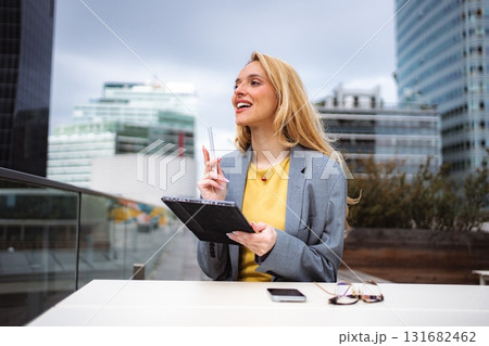 Businesswoman having idea using tablet in city 131682462