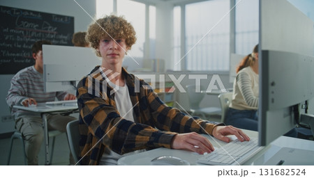 Curly Haired Young Man Working on Game Development Project Curly Haired Young Man Working on Game Development Project 131682524
