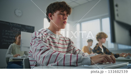 In College Classroom, Brown Haired Guy Doing Practical Task in Game Development In College Classroom, Brown Haired Guy Doing Practical Task in Game Development 131682539