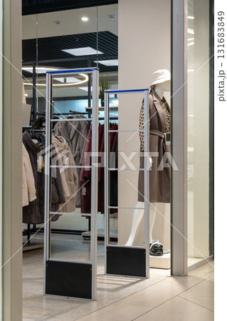 Radio-frequency security gates with integrated metal detector at a clothing store entrance 131683849