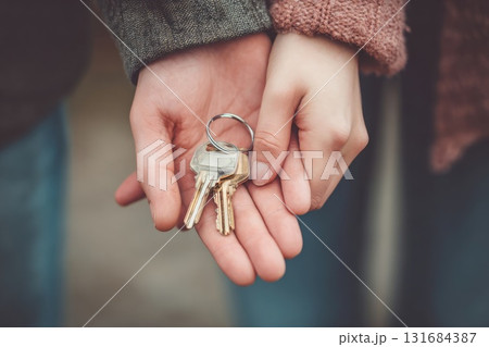 Ai generated Hands holding house keys with small home keychain 131684387