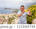 Tourist man caking photos of city of Kas in Turkey from a panoramic viewpoint 131684748