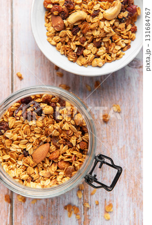 Granola cereal in glass jar, healthy breakfast concept Granola cereal in glass jar, healthy breakfast concept 131684767