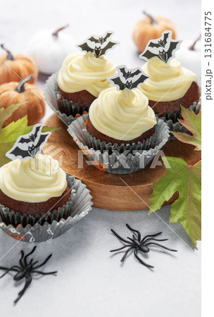 Halloween cupcakes with bats, pumpkins, and autumn leaves Halloween cupcakes with bats, pumpkins, and autumn leaves 131684775