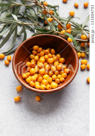Sea buckthorn berries in bowl, harvesting healthy superfood 131684791