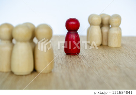 Peg wooden figures facing a red one showing respect and recognition of a leader. Peg wooden figures facing a red one showing respect and recognition of a leader. 131684841