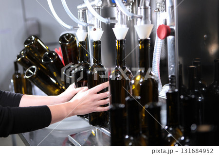 Wine is bottled. Small craft winery. Empty wine bottles. Concept of small wine production. Author's wine of new harvest Wine is bottled. Small craft winery. Empty wine bottles. Concept of small wine production. Author's wine of new harvest 131684952