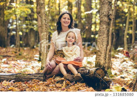 Mature mother with daughter on autumn forest. Mature mother with daughter on autumn forest. 131685080