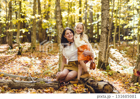 Mature mother with daughter on autumn forest. Mature mother with daughter on autumn forest. 131685081