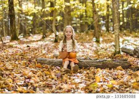 happy child girl throws autumn leaves and laughs outdoors happy child girl throws autumn leaves and laughs outdoors 131685088