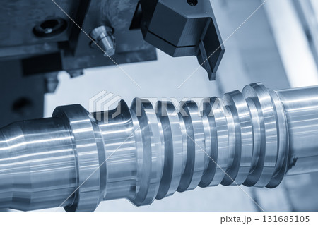 The  CNC lathe machine groove cutting the metal ball screw shaft parts in the light blue scene. 131685105