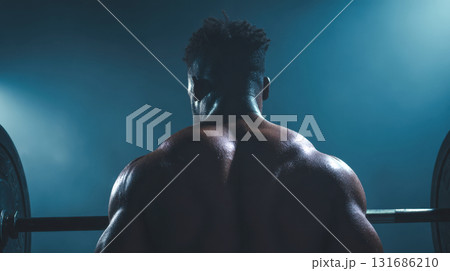 Strong man lifting weights in gym 131686210