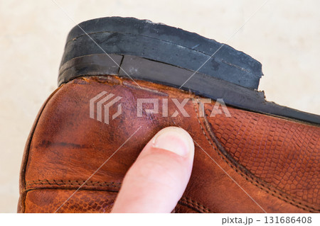 Old Worn-Out Men's Leather Shoes with Defects, Broken Heel and Sole, Showcasing the Signs of Time and Use in Fashion and Footwear Old Worn-Out Men's Leather Shoes with Defects, Broken Heel and Sole, Showcasing the Signs of Time and Use in Fashion and Footwear 131686408