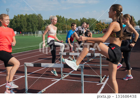 Athletes Training with Hurdles on Running Track Athletes Training with Hurdles on Running Track 131686438