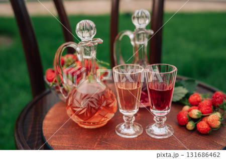Strawberry Liqueur in Elegant Glass Decanters Outdoors Strawberry Liqueur in Elegant Glass Decanters Outdoors 131686462