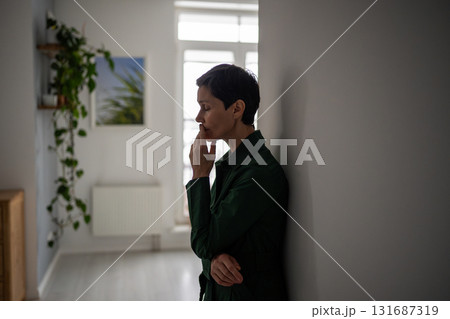 Tired hopeless mature woman leaning on wall in mental struggle and deep personal crisis alone Tired hopeless mature woman leaning on wall in mental struggle and deep personal crisis alone 131687319