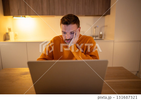 Burnout man working on laptop after yesterday party, suffering from hangover, migraine, strain 131687321