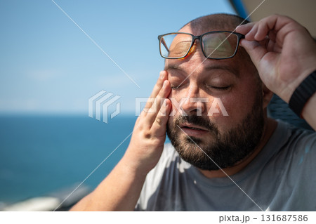 Overweight man wipes sweat face with suffering from summer sun sunstroke abnormally high temperature Overweight man wipes sweat face with suffering from summer sun sunstroke abnormally high temperature 131687586