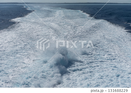 Serene Wake of a Boat on a Sunny Sea Day Serene Wake of a Boat on a Sunny Sea Day 131688229