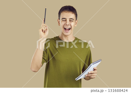 Active teen, smart young man cute teenage person with pencil and notebook Active teen, smart young man cute teenage person with pencil and notebook 131688424