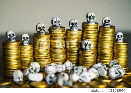 Skulls on stacks of gold coins symbolizing greed, corruption, financial risk, and mortality concept Skulls on stacks of gold coins symbolizing greed, corruption, financial risk, and mortality concept 131689404