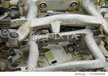 Used aluminum automotive suspension parts and frames stacked for recycling and scrap industry 131689466