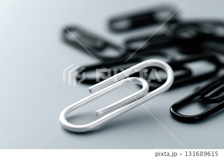 Papers organized with silver and black paper clips on a smooth surface in a neat arrangement 131689615