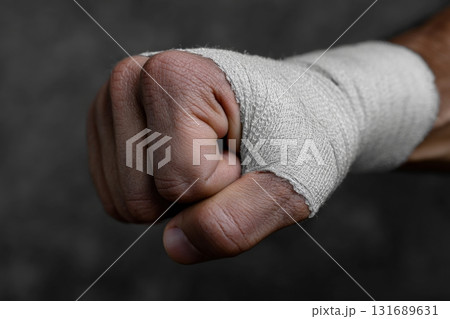 Hand with bandage shows recovery after injury in a dark environment 131689631