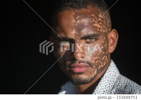 Portrait of a young man with striking eyes and unique facial patterns in natural light 131689751