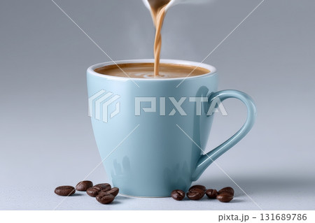 Steaming coffee being poured into a light blue mug with coffee beans on the table Steaming coffee being poured into a light blue mug with coffee beans on the table 131689786
