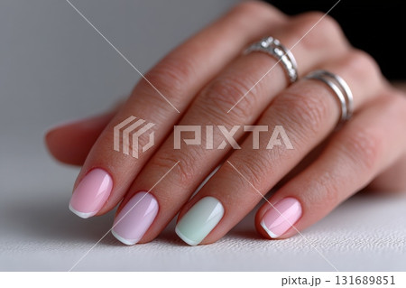 Elegant pastel nail art featuring gradient shades and delicate French tips in a minimalist setting 131689851