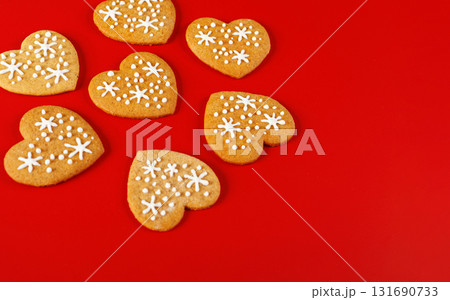 beautiful hand-baked cookies in the shape of a heart on a red background 131690733