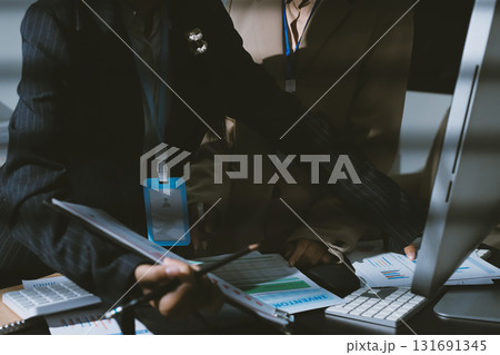 Close up high angle Asian businesswoman working with her coworker in meeting room Close up high angle Asian businesswoman working with her coworker in meeting room 131691345