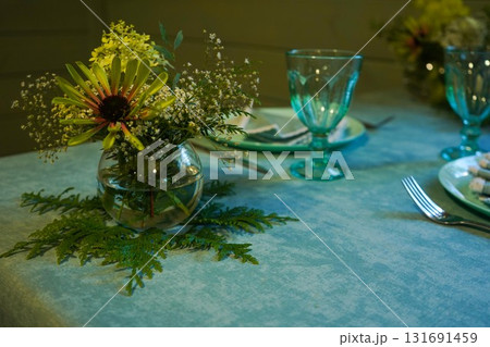 The festive table setting includes a stylish napkin on the plate, enhancing the overall look and making the meal feel extra special. The festive table setting includes a stylish napkin on the plate, enhancing the overall look and making the meal feel extra special. 131691459