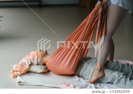 Wellness session for relaxation with guided stretching in a serene studio environment during a calm afternoon 131692050