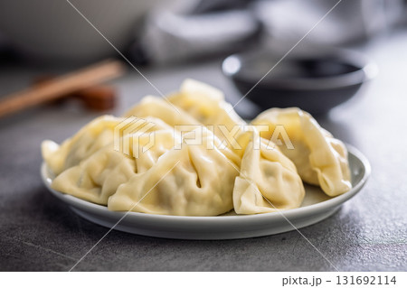 Traditional japanese gyoza dumplings and soy sauce on kitchen table. Traditional japanese gyoza dumplings and soy sauce on kitchen table. 131692114