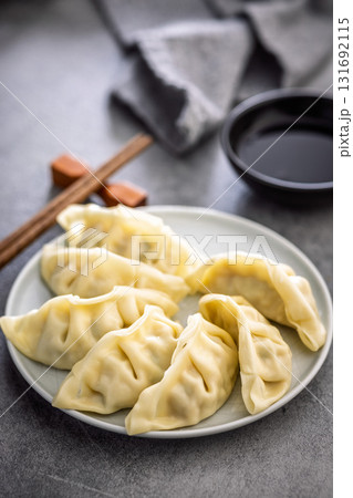 Traditional japanese gyoza dumplings and soy sauce on kitchen table. Traditional japanese gyoza dumplings and soy sauce on kitchen table. 131692115