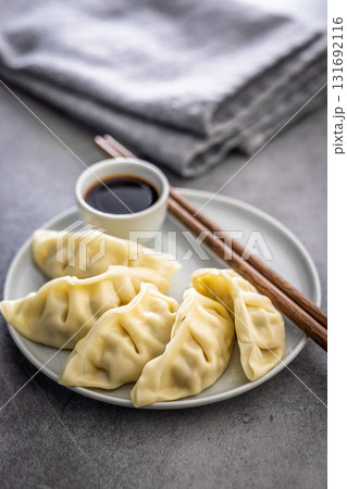 Traditional japanese gyoza dumplings and soy sauce on kitchen table. 131692116