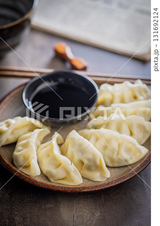 Traditional japanese gyoza dumplings and soy sauce on kitchen table. 131692124