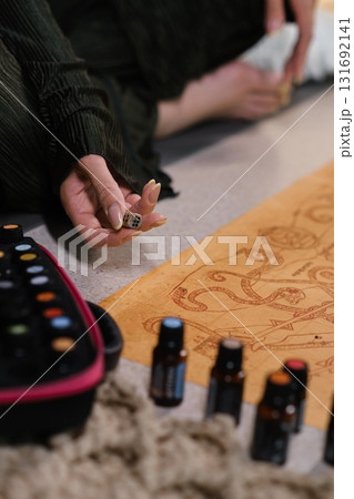 Creative session focused on natural elements with essential oils and artistic expression in a cozy indoor setting 131692141