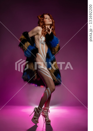 Beauty woman showcasing artistic body art with tape and fur in studio setting 131692200