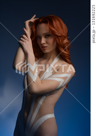 Beauty woman showcasing creative body art in studio setting with fur Beauty woman showcasing creative body art in studio setting with fur 131692225