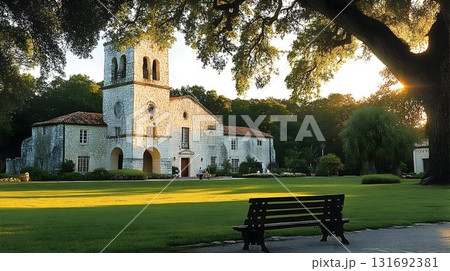 Mediterranean-style building with bell tower bathed in golden su Mediterranean-style building with bell tower bathed in golden su 131692381