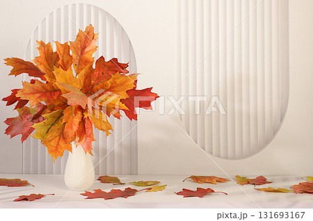 Autumn abstract composition with maple leaves in a vase on an elegant modern kitchen table, still life and Thanksgiving concept, seasonal background and banner for screen, greeting card. Autumn abstract composition with maple leaves in a vase on an elegant modern kitchen table, still life and Thanksgiving concept, seasonal background and banner for screen, greeting card. 131693167