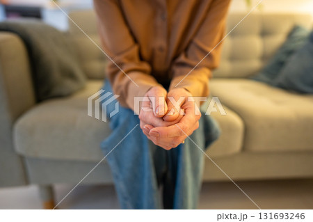 Close up woman hands crossed nervously, anxiously await news on couch. Fear and mental issues 131693246