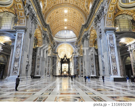 Interior view of St.Peters Basilica in Vatican City, showcasing its ornate Baroque architecture, grand columns, gilded ceiling, and visitors admiring the sacred space. Interior view of St.Peters Basilica in Vatican City, showcasing its ornate Baroque architecture, grand columns, gilded ceiling, and visitors admiring the sacred space. 131693289