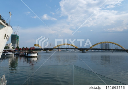 Dragon Bridge in Da Nang Vietnam steel dragon architecture over Han River with LED lights sky reflection and scenic coastal river view 131693336