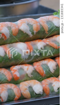 Tasty spring rolls served with lettuce on white background Tasty spring rolls served with lettuce on white background 131693341
