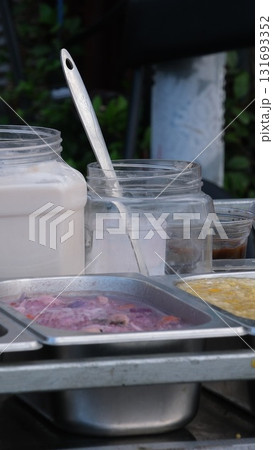 lively and flavorful essence of Ballarò Market. A bustling food stall serves up iconic Sicilian street foods including arancini, panelle and sfincione 131693352