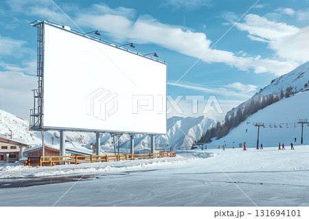 Large blank billboard in snowy ski resort with people skiing nearby under a blue sky. Concept of advertising in winter recreation areas. For outdoor ad mockup. Large blank billboard in snowy ski resort with people skiing nearby under a blue sky. Concept of advertising in winter recreation areas. For outdoor ad mockup. 131694101